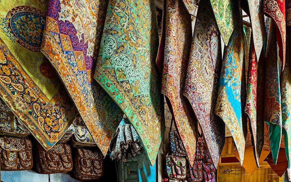 Folded shawls and scarves in soft colours