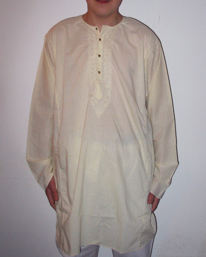 Cream cotton kurta worn with a textured Nehru vest and white churidar